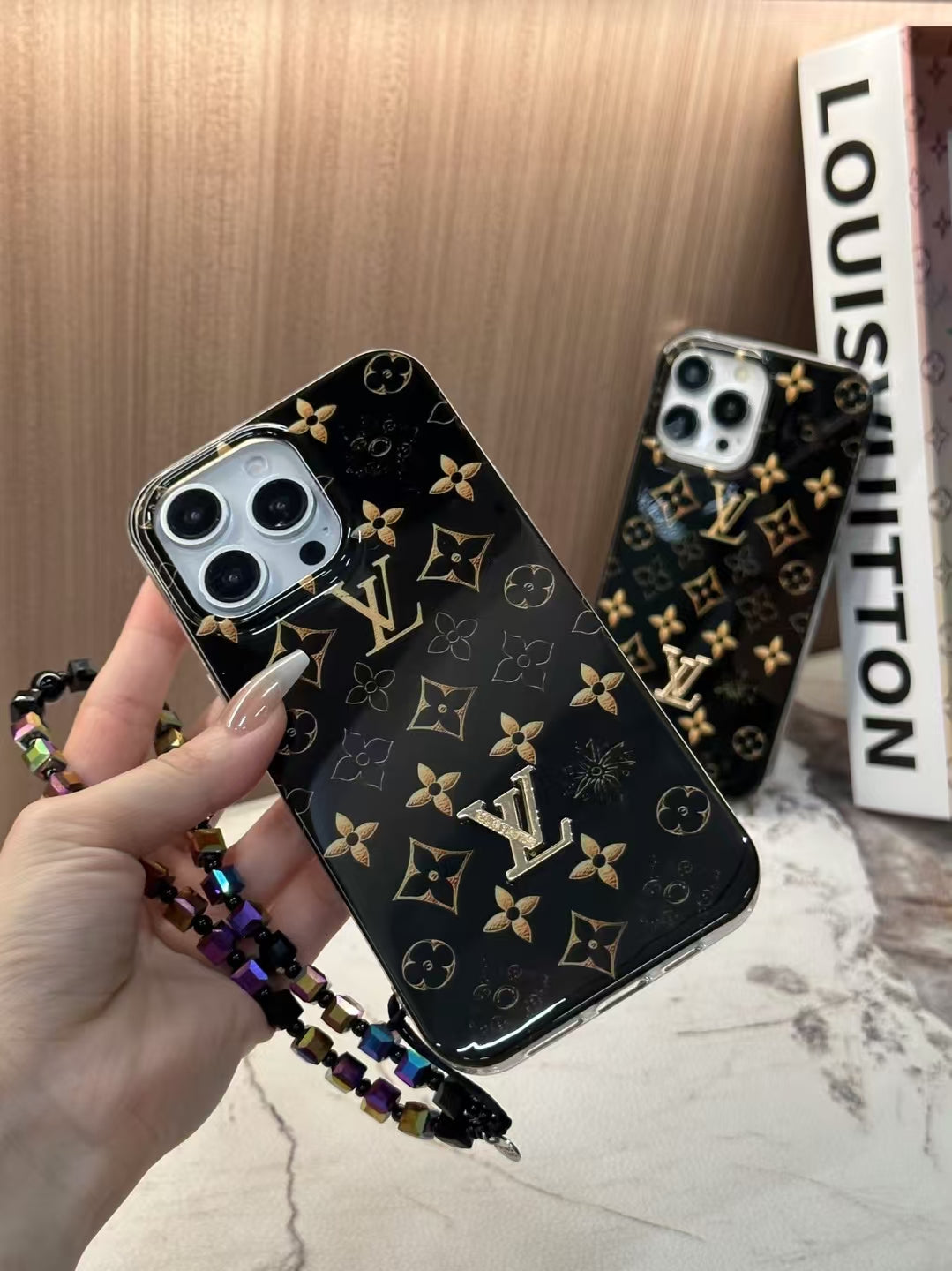 Luxury Black Monogram iPhone Case with Gold Accents and Charm Strap