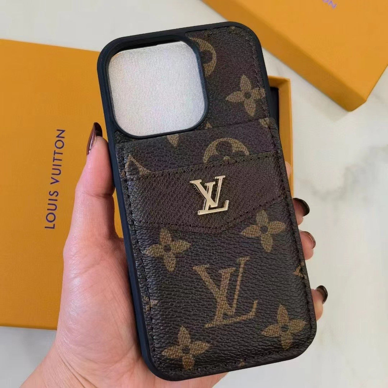 Close-up of LV Monogram wallet iPhone case with card slots